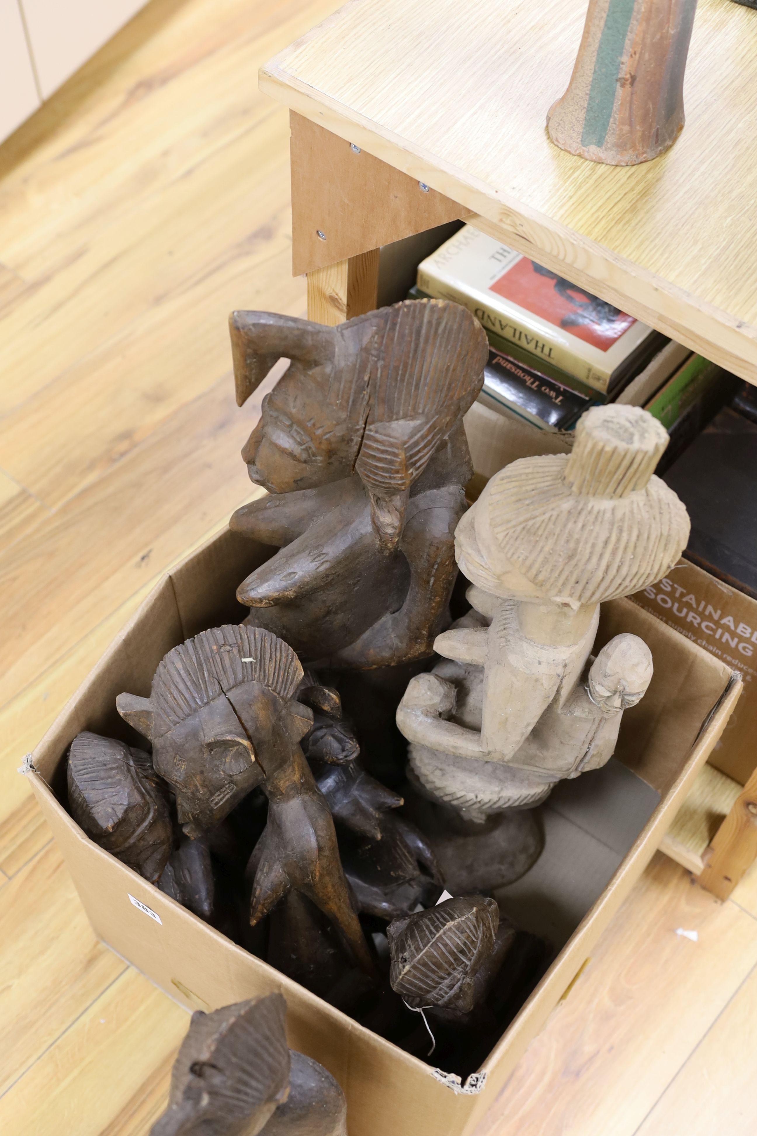 A collection of Nigerian carved wood fertility symbol figures, tallest 70cm.